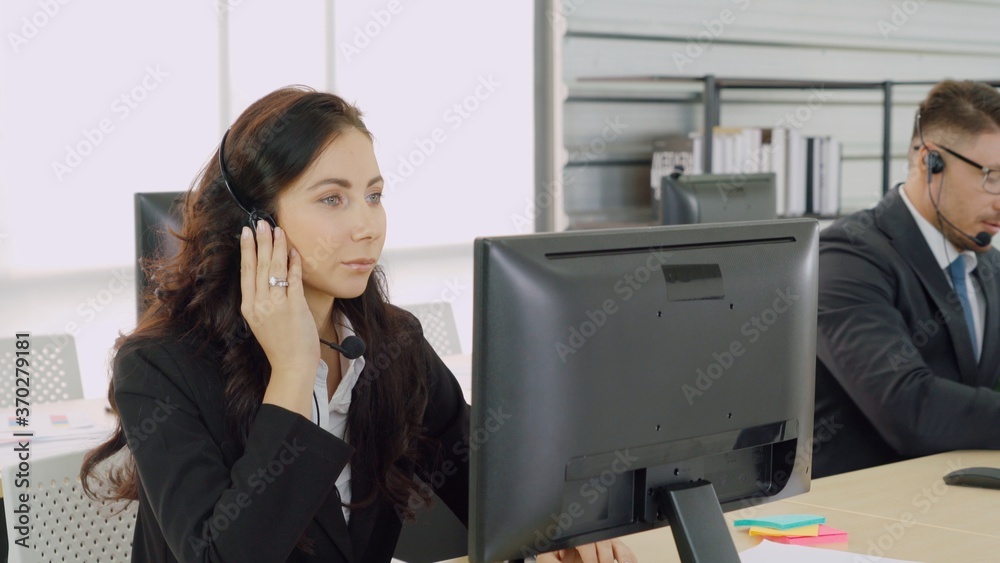 Business people wearing headset working in office to support remote customer or colleague. Call cent