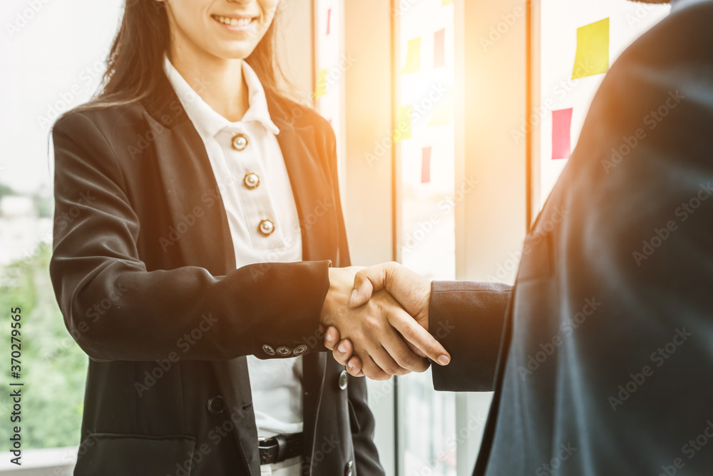 Business people handshake in corporate office showing professional agreement on a financial deal con