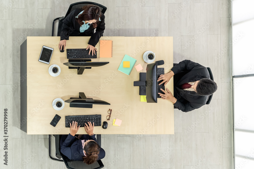 Business people wearing headset from top view in office working with computer to support remote cust