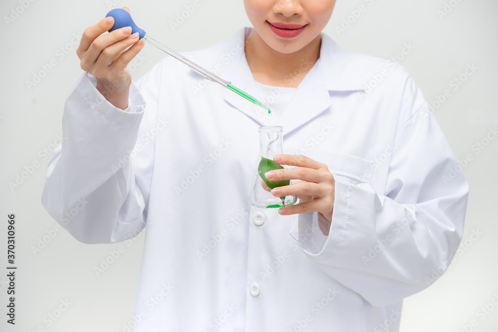 Candid shot of beautiful young Asian female researcher conducting experiment in laboratory,