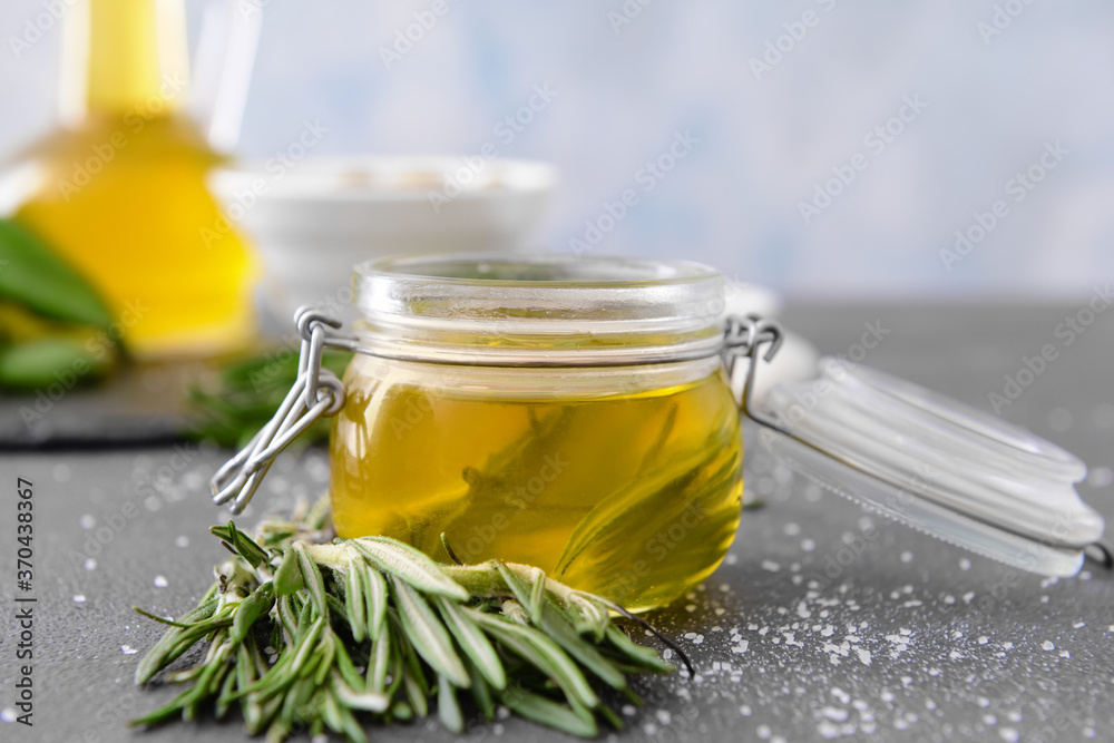 Jar of rosemary oil on table