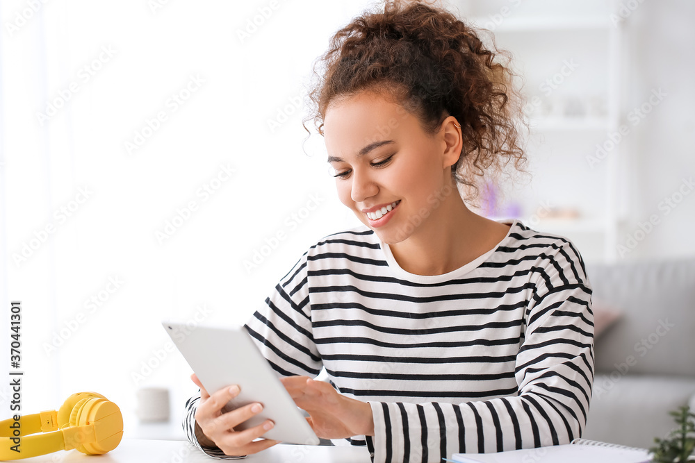 Young woman using tablet computer for online learning at home