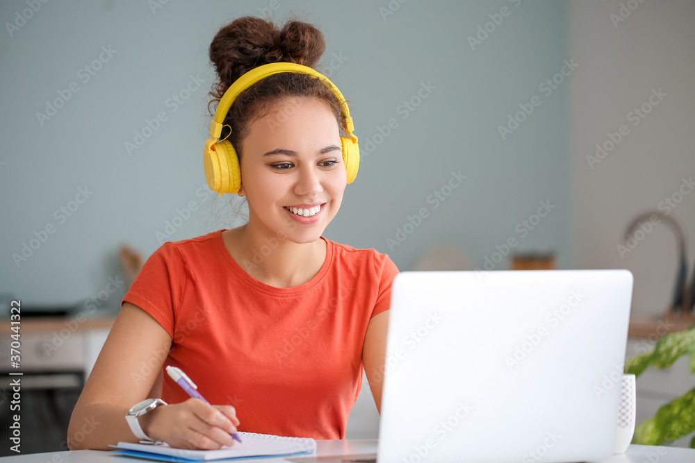 Young woman using laptop for online learning at home