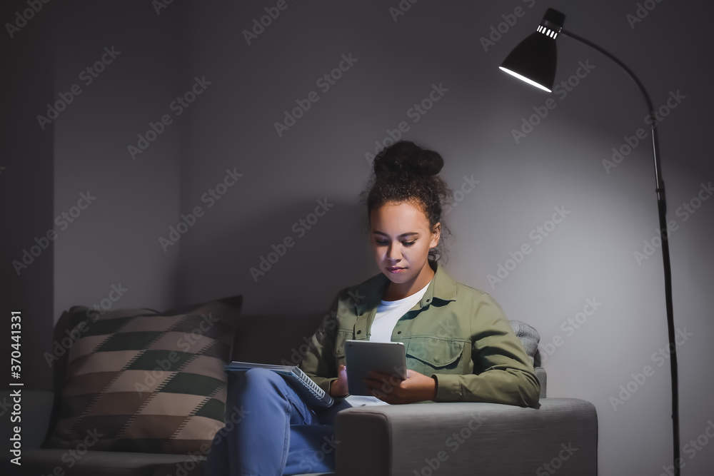 Young woman using tablet computer for online learning at home