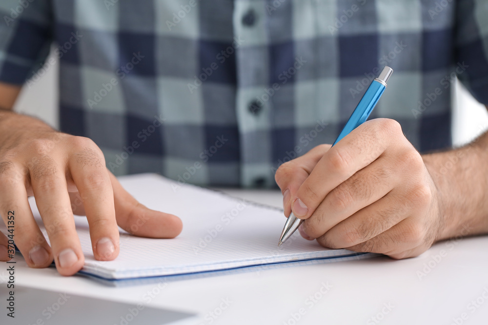 Young man learning at home, closeup