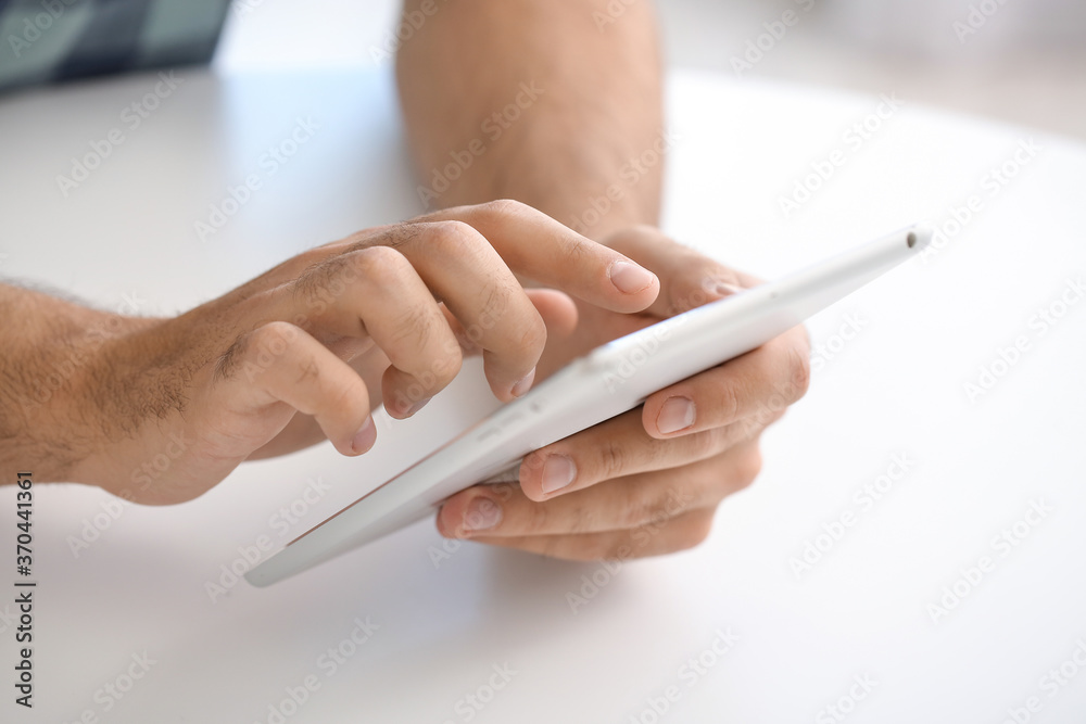 Young man using tablet computer for online learning at home