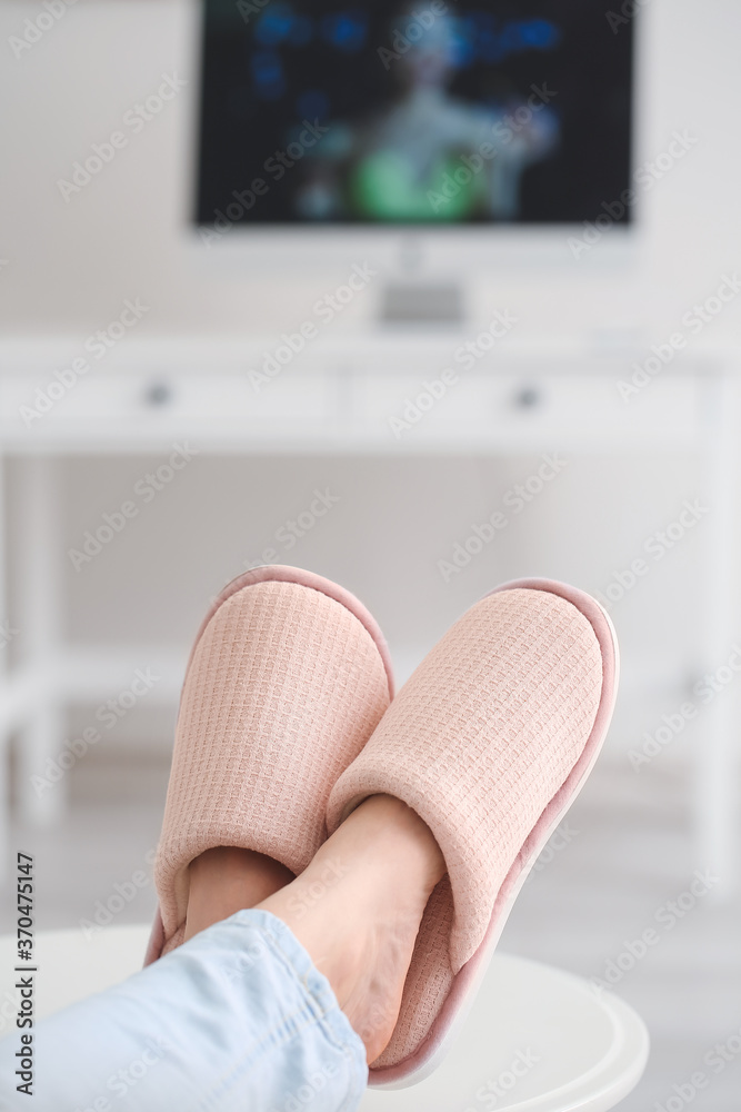 Young woman in soft slippers at home