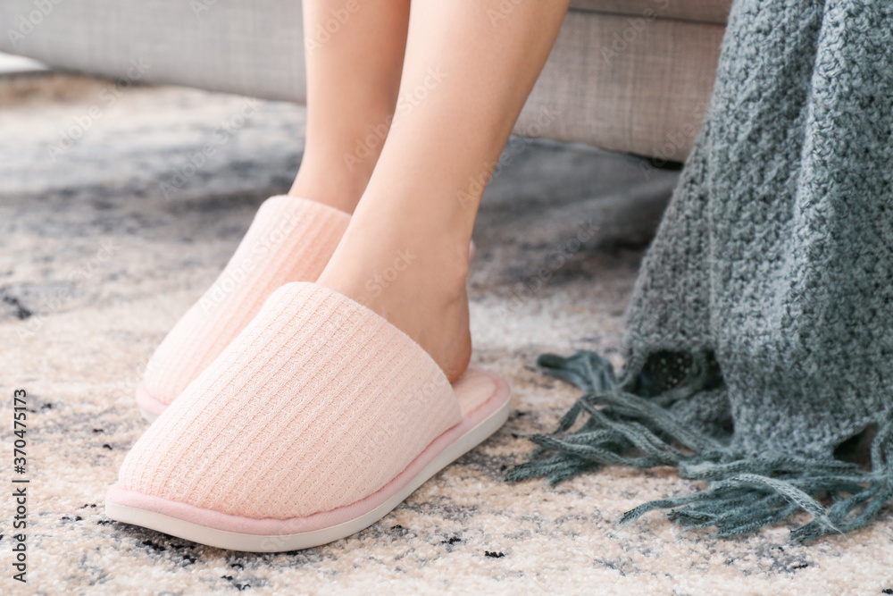 Young woman in soft slippers at home