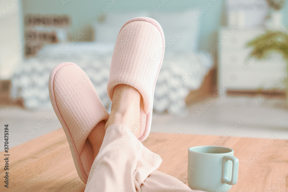 Young woman in soft slippers at home