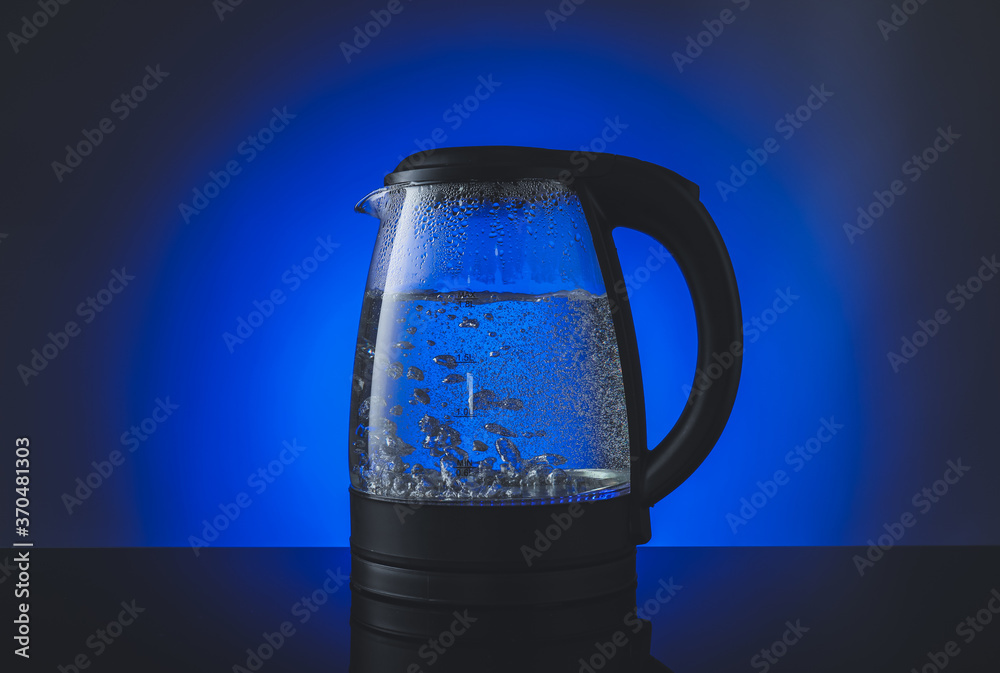 Modern electric kettle on color background