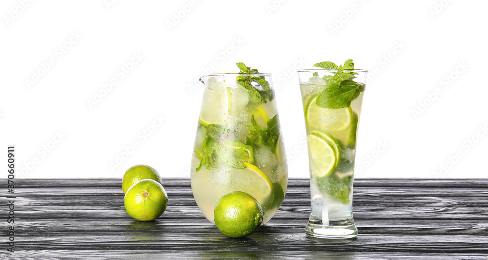 Glassware of fresh mojito on table against white background