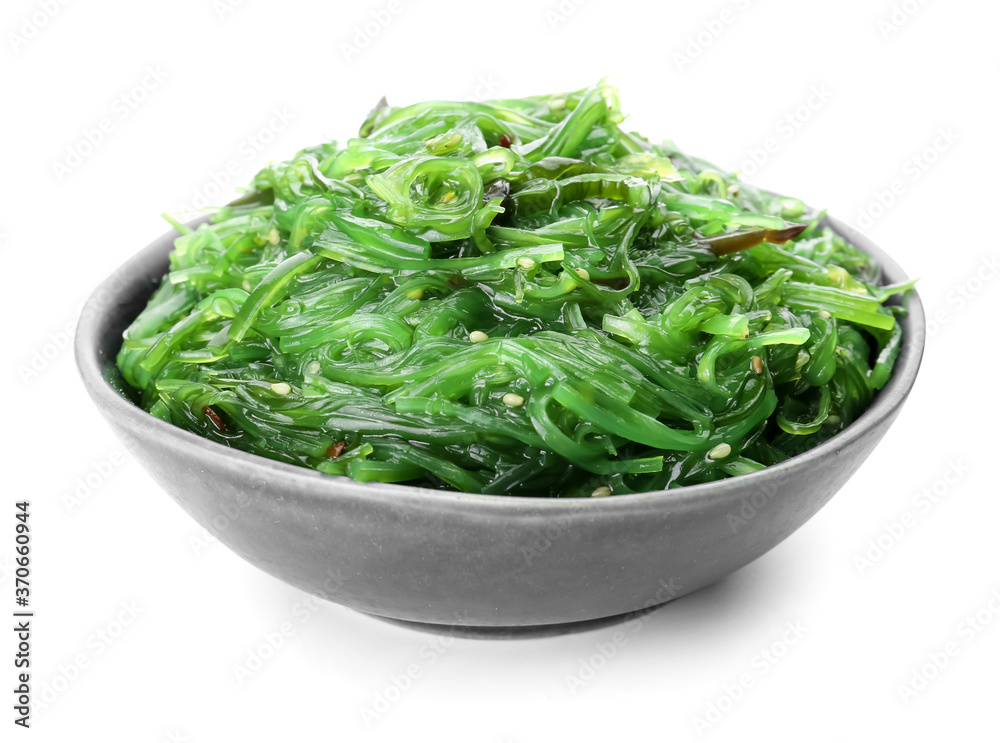 Bowl with tasty seaweed salad on white background