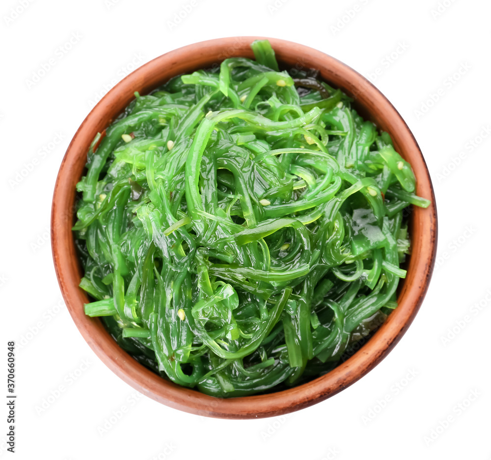 Bowl with tasty seaweed salad on white background