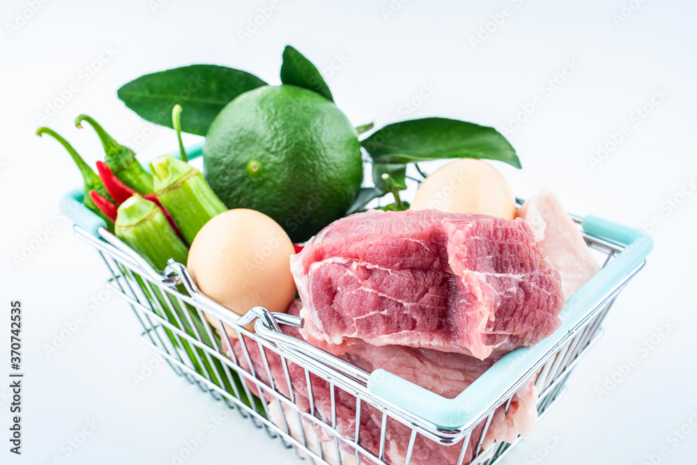 Vegetable basket full of pork, vegetables and fruits