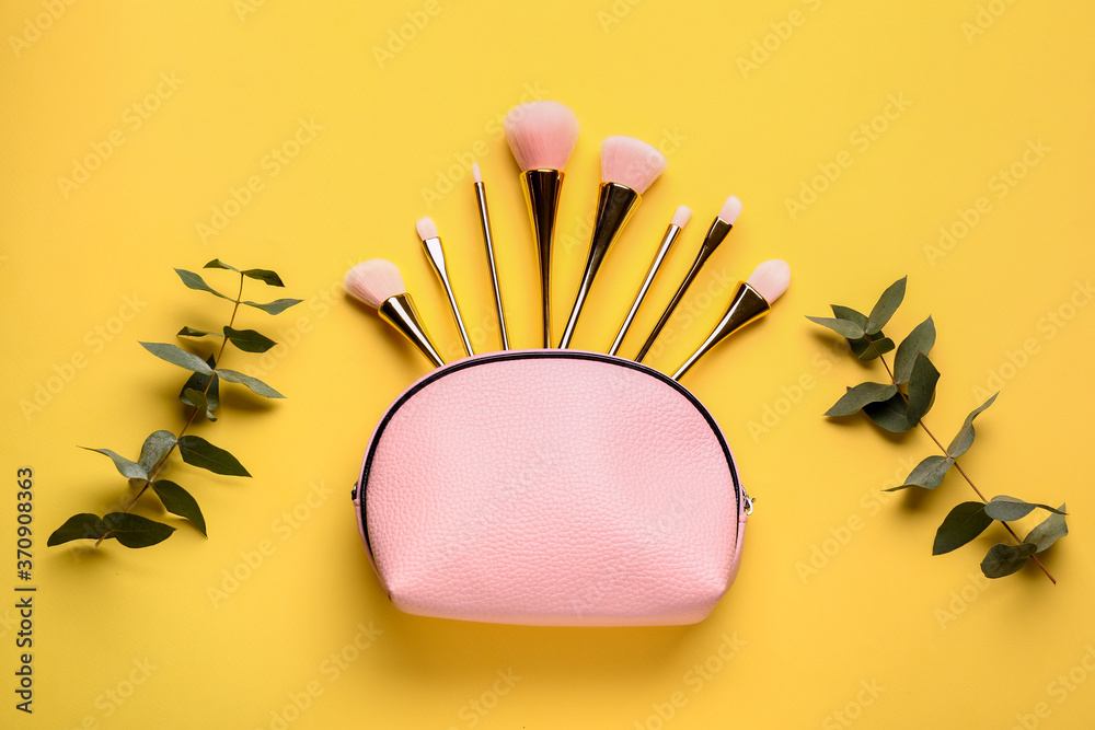 Composition with cosmetic bag on color background