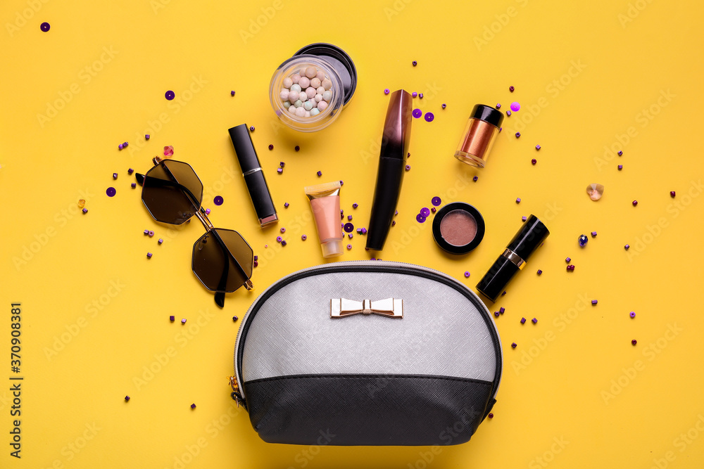 Composition with cosmetic bag on color background