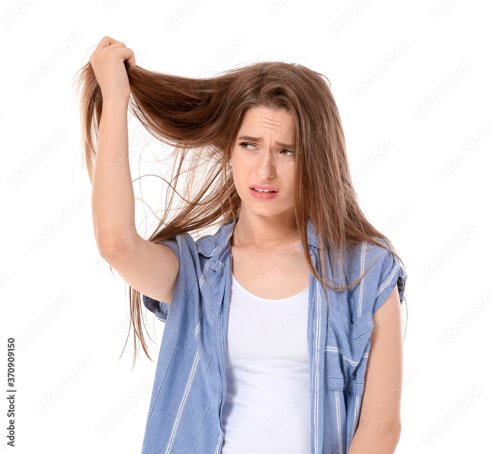 Stressed woman with hair problem on white background