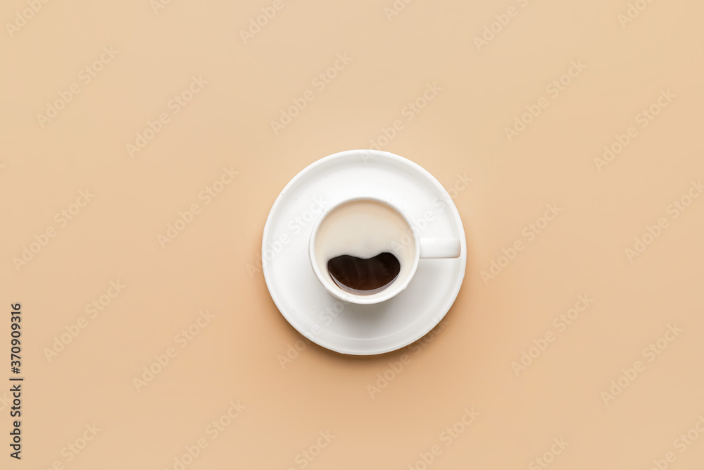 Cup of hot coffee on color background