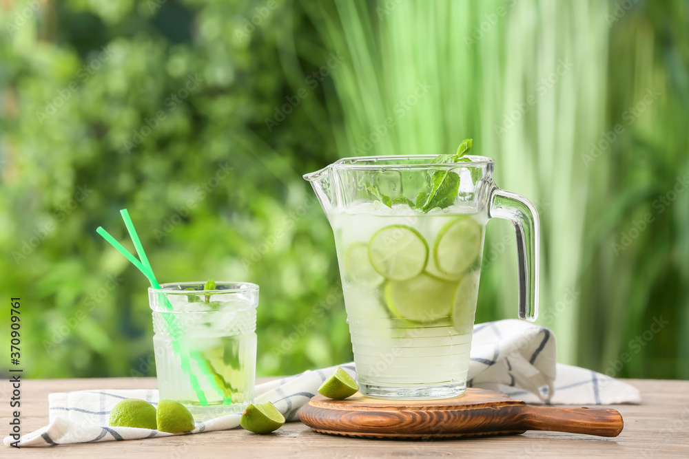 Composition with fresh mojito on table outdoors