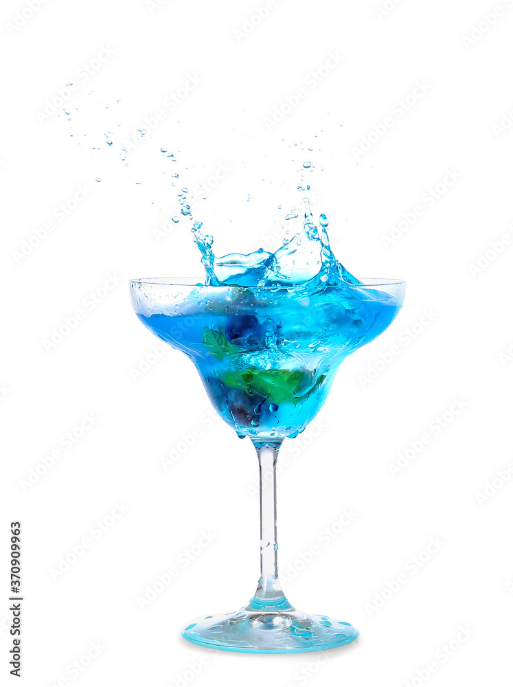 Glass of tasty blue mojito cocktail with splashes on white background