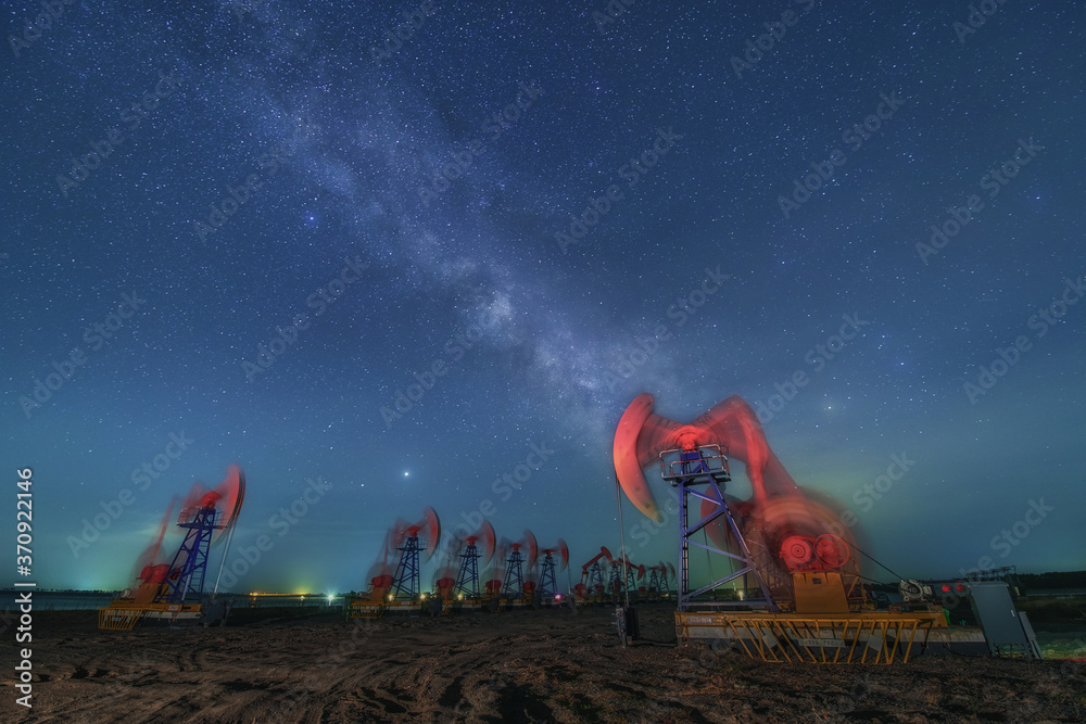 The pumping units under the starry in night.