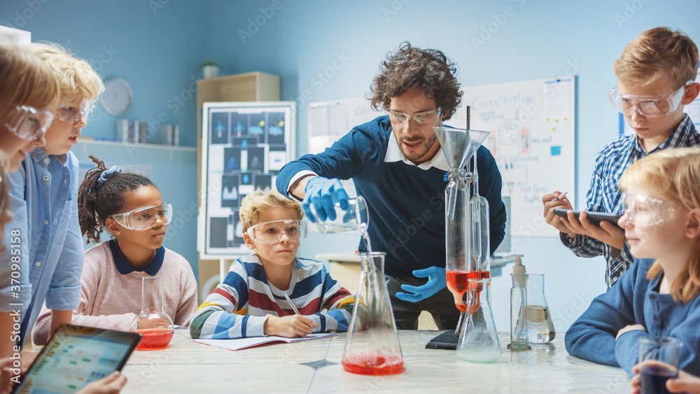 Elementary School Chemistry Classroom: Enthusiastic Teacher Teaches Diverse Group of Children Shows 