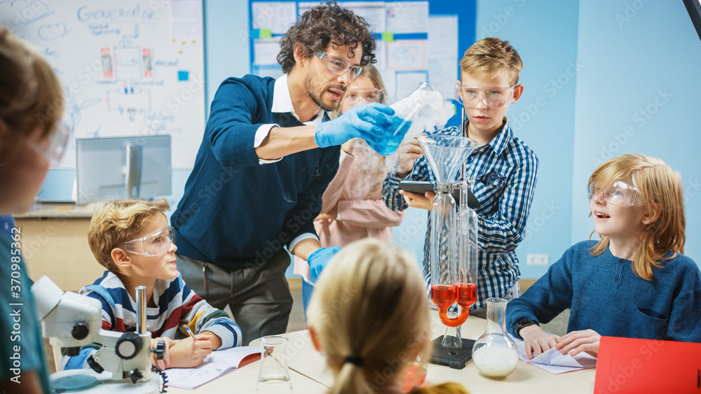 Elementary School Science Classroom: Enthusiastic Teacher Explains Chemistry to Diverse Group of Chi