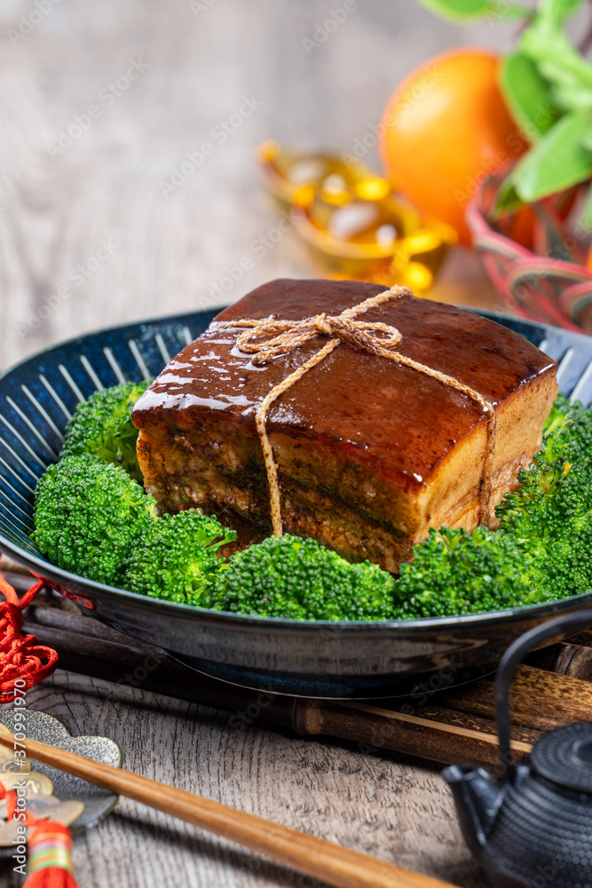 Dong Po Rou (Dongpo pork meat) in a beautiful blue plate with green broccoli vegetable, traditional 