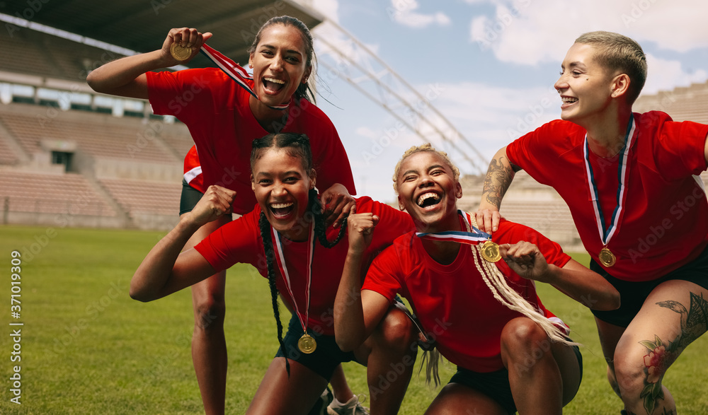 Female soccer team cheering together after the game league