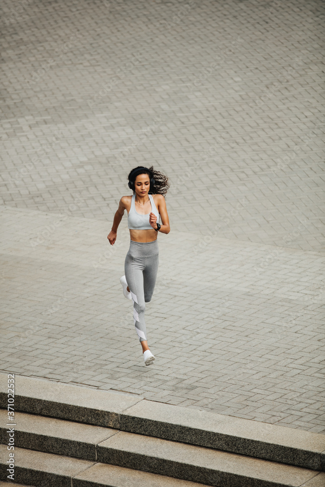 Fit woman sprinting in the city