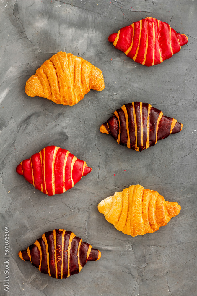 Croissants pattern - set of snacks on dark stone background