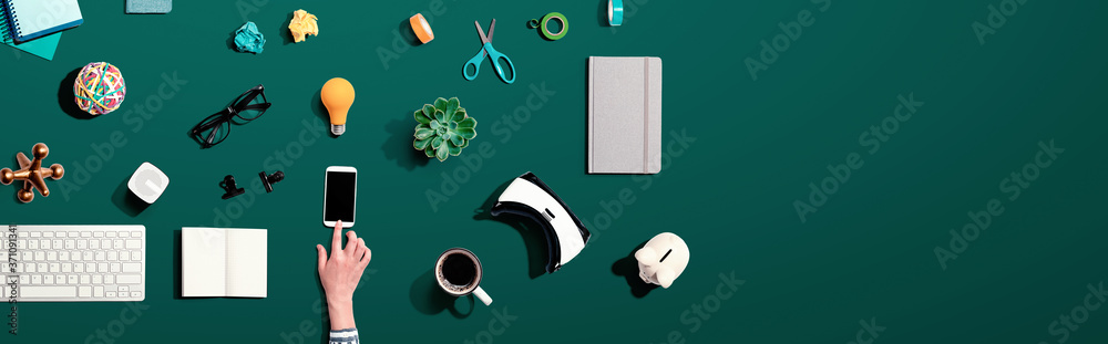 Collection of electronic gadgets and office supplies - flat lay