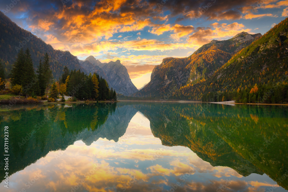 Dolomites mountains with reflection in Lago di Dobbiaca lake at sunrise. Italy