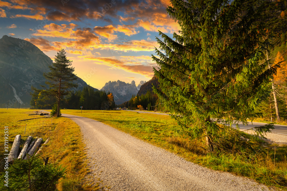 Idyllic mountain road through the Dolomites at sunset. Italy