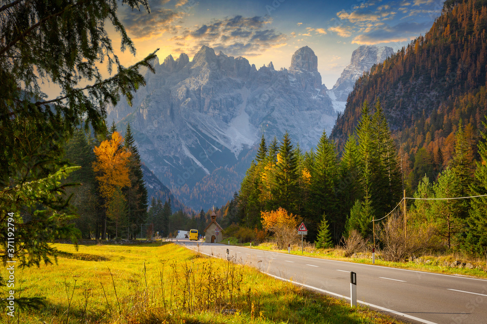 Idyllic mountain road through the Dolomites at sunset. Italy