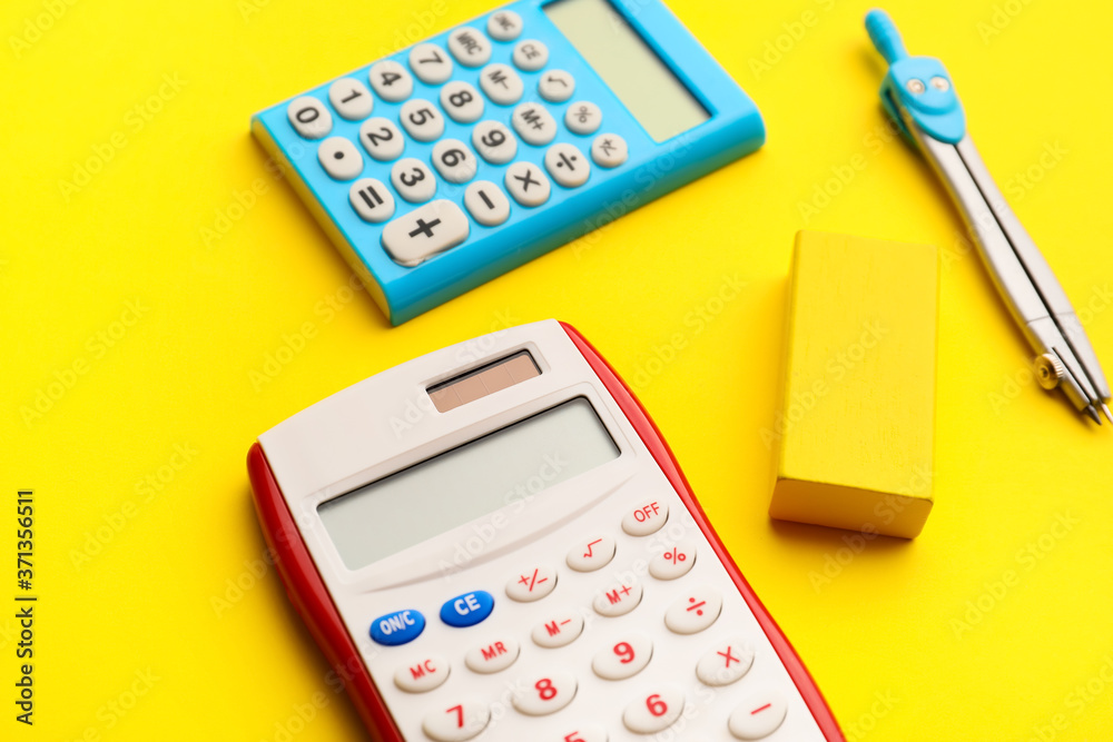 Calculators and pair of compasses on color background