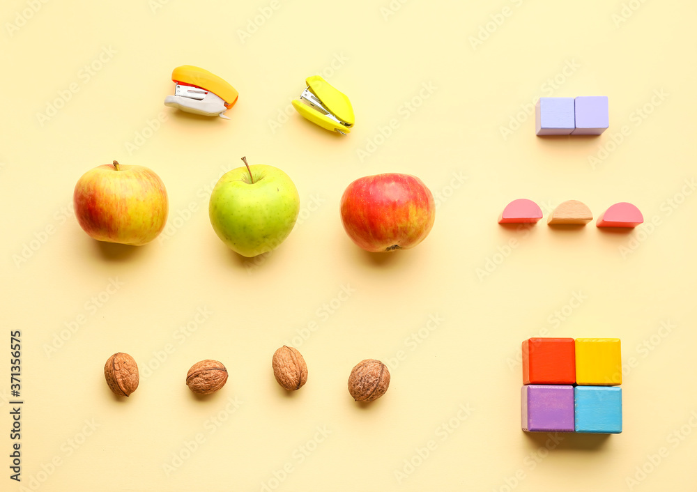 Food and wooden figures on color background. Maths concept