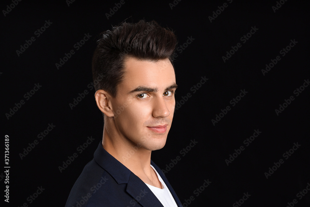 Handsome man with stylish hairdo on dark background