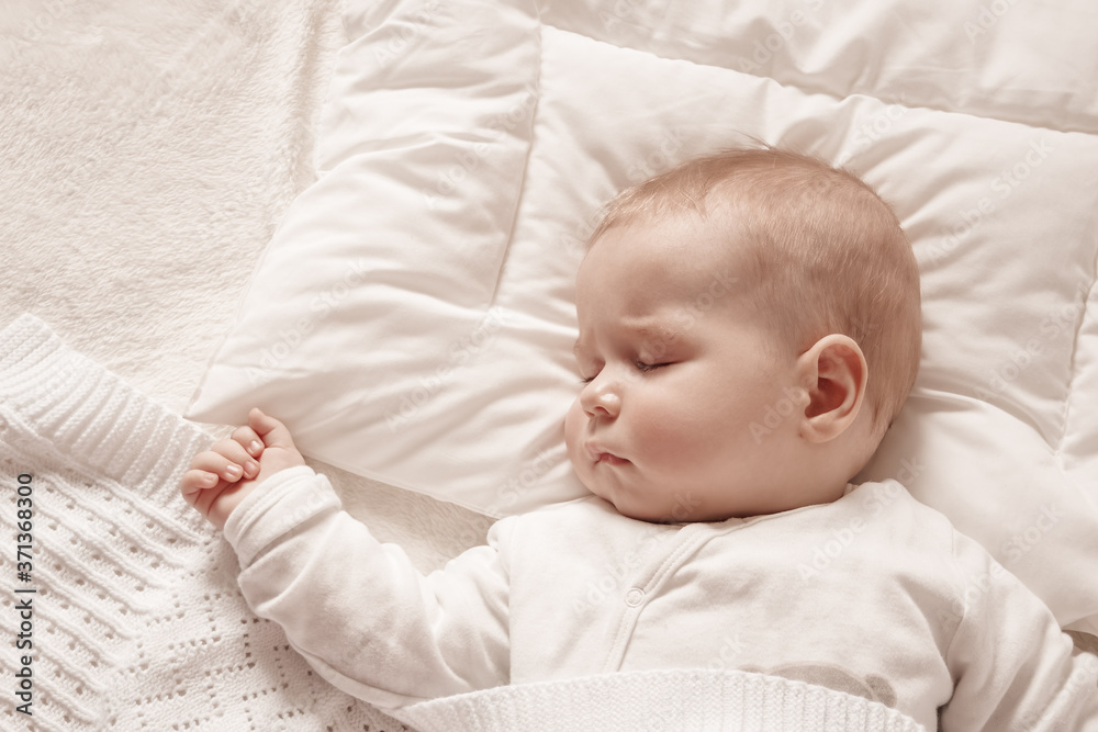 Baby boy sleeping covered with soft blanket