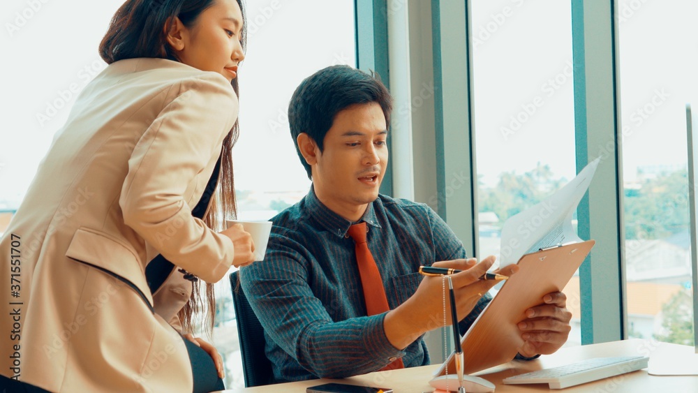 Two business people talk project strategy at office meeting room. Businessman discuss project planni