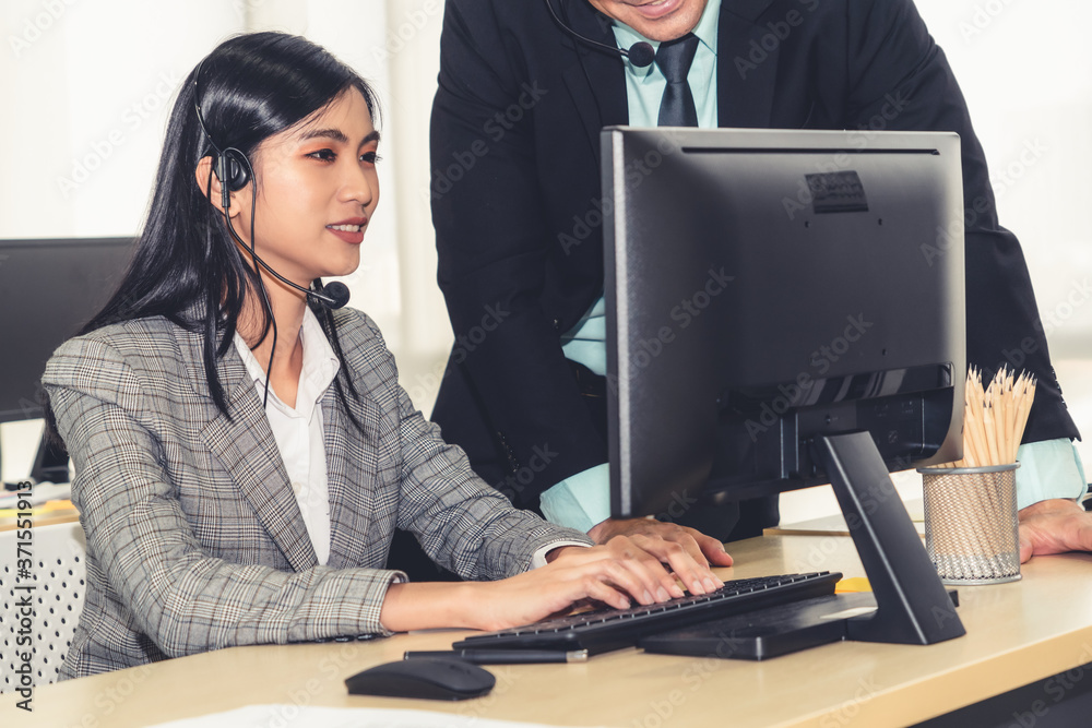 Business people wearing headset working in office to support remote customer or colleague. Call cent