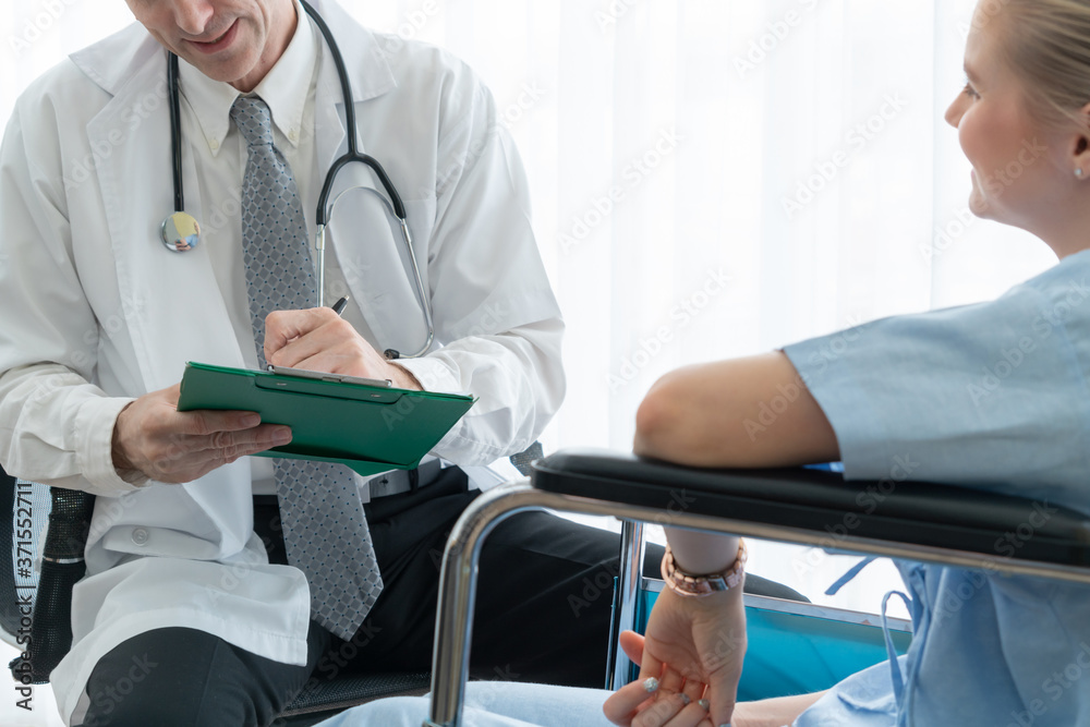 Doctor in professional uniform examining patient at hospital or medical clinic. Health care , medica