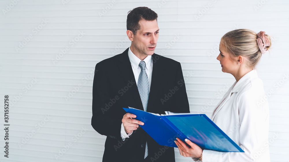 Two business people talk project strategy at office meeting room. Businessman discuss project planni