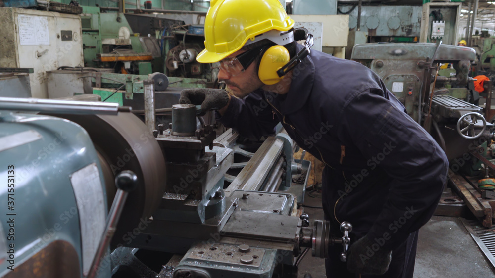 Smart factory worker using machine in factory workshop . Industry and engineering concept.