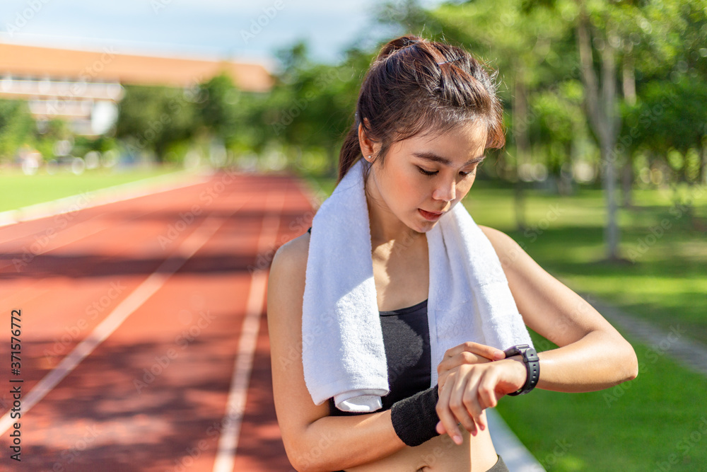 美丽的年轻亚洲女性早上在跑道上锻炼