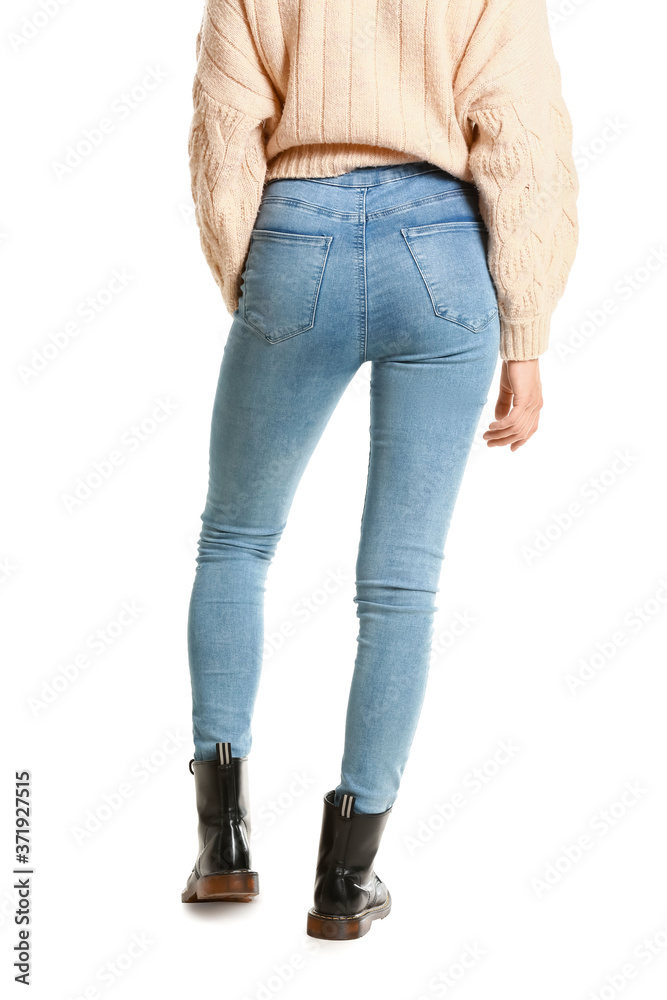 Beautiful young woman in jeans on white background