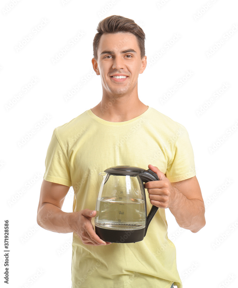 Young man with electric kettle on white background