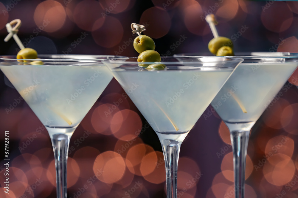 Glasses of fresh martini on dark background, closeup