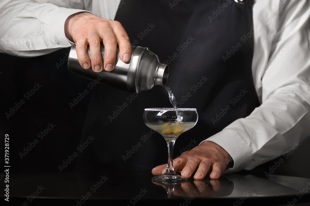 Bartender making fresh martini in pub