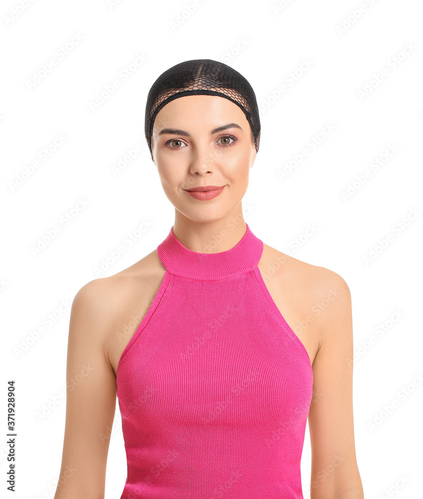 Beautiful young woman in cap for wig on white background